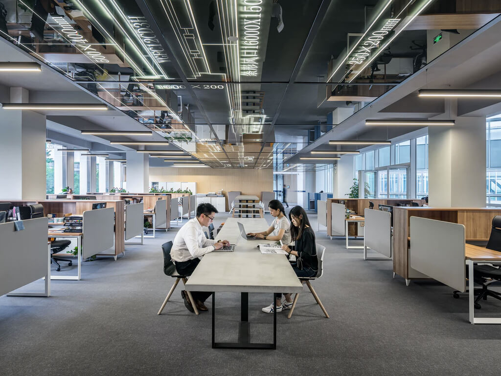 Employees sitting to their chairs at the office lobby.